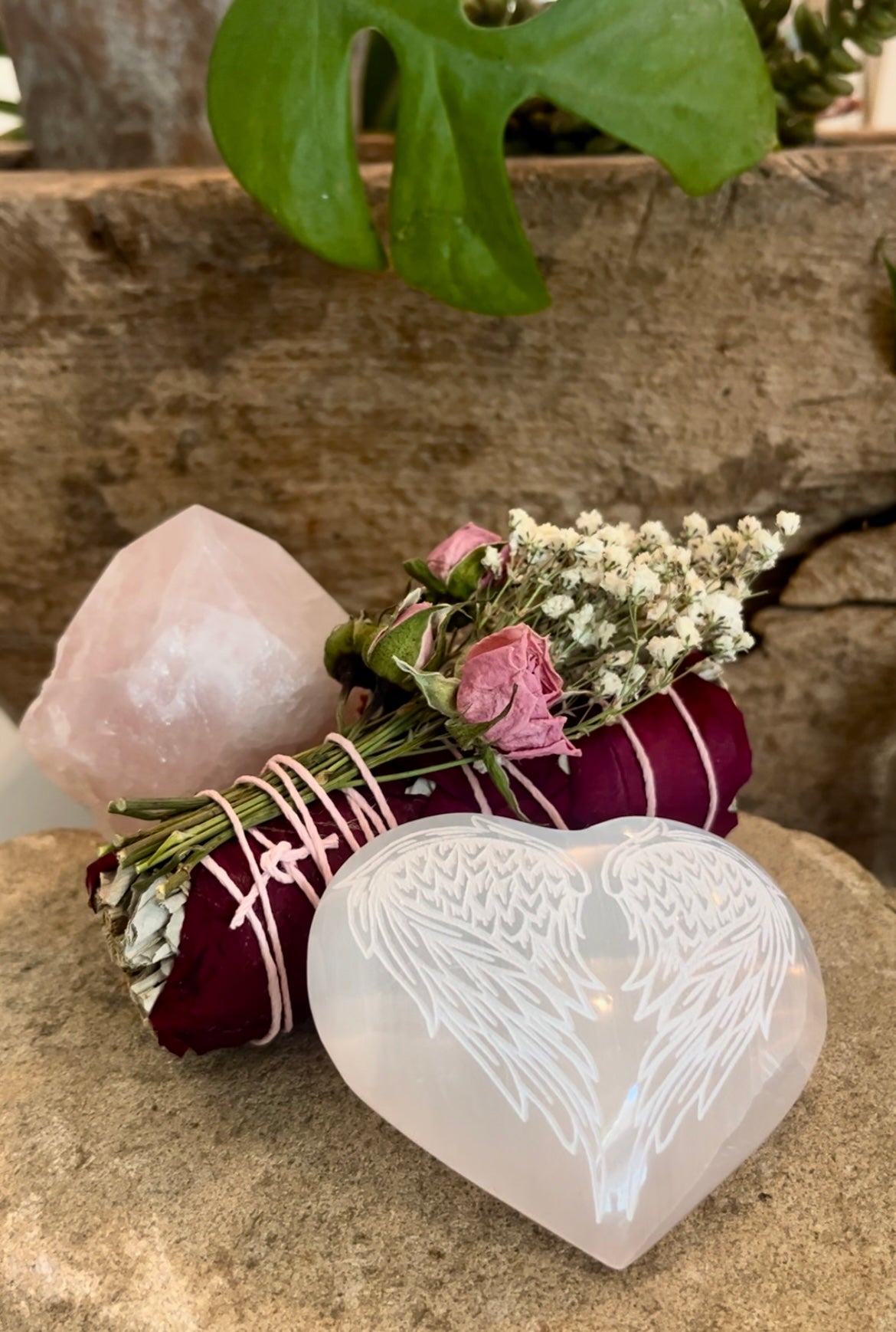 Rose Quartz Crystal Point with Floral Sage Rose Baby's Breath smudge bundle and heart-shaped selenite crystal with engraved angel wings.