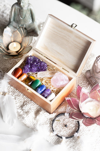 Chakra balancing crystal set with 10 healing stones - raw amethyst cluster, rose quartz, clear quartz point, red jasper, carnelian, tigers eye, green aventurine, sodalite, amethyst and white howlite in an engraved wooden keepsake box.