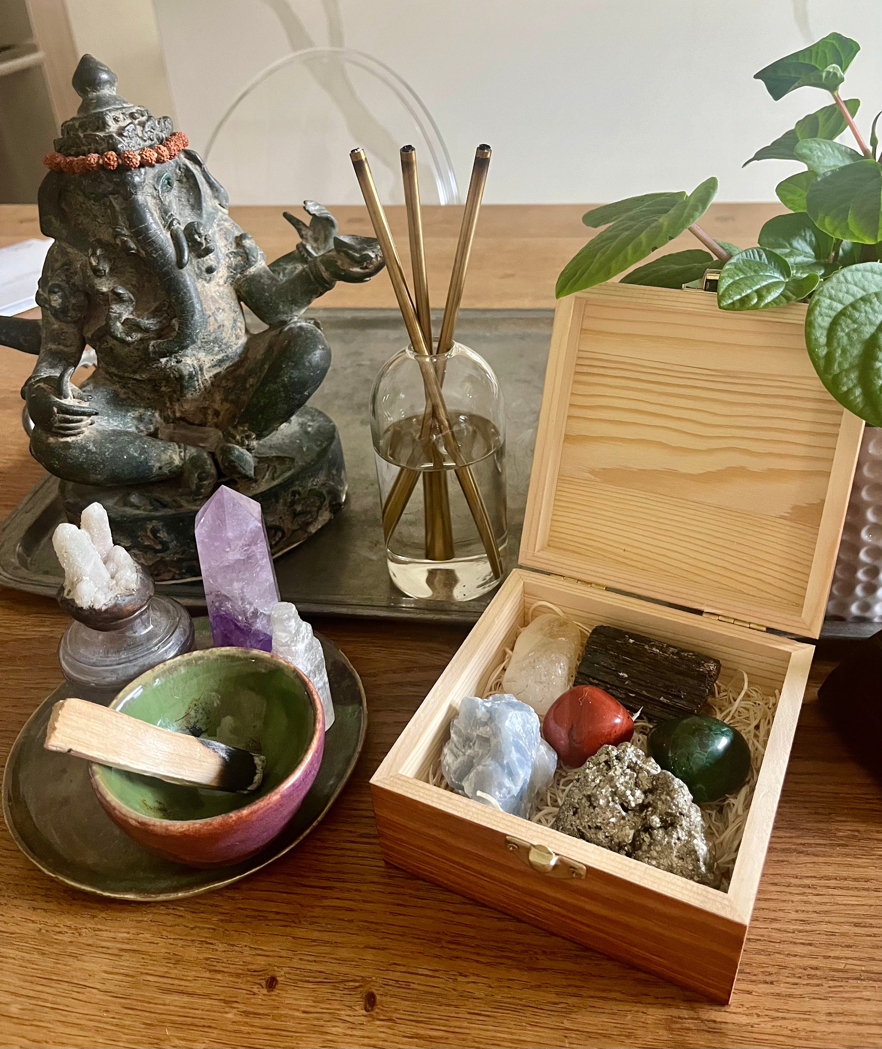 Feng Shui Crystal Set in engraved wooden display box showcasing pyrite, black tourmaline, citrine, red jasper, malachite and blue calcite.